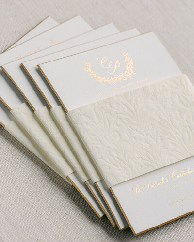 Blind impression velvet belly band on gold foil letterpress wedding invitation