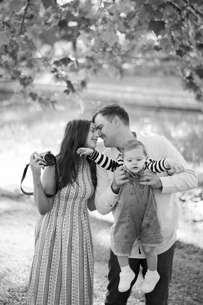 Allison jumping in the air holding her camera above her head