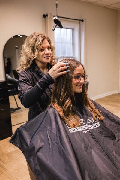Hair stylist Holly doing customer's hair
