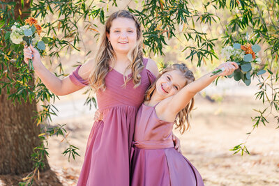 Two junior bridesmaids celebrating at a Raleigh venue by JoLynn Photography