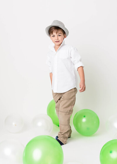 5 year old boy studio portrait with balloons