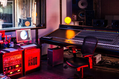 Location Branding photo interior Gatos Trail Recording Studio mixing board lit with red light