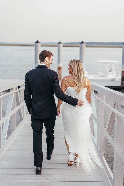 Bride and groom walking on a dock in beaufort sc