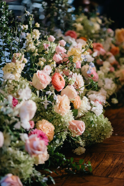 Beautiful floral display on table cloth with candles lit