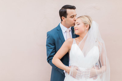 Charleston Bride in Hayley Paige Decklyn Wedding Dress and Veil with Groom in Navy Blue Suit with Blush Pink Tie