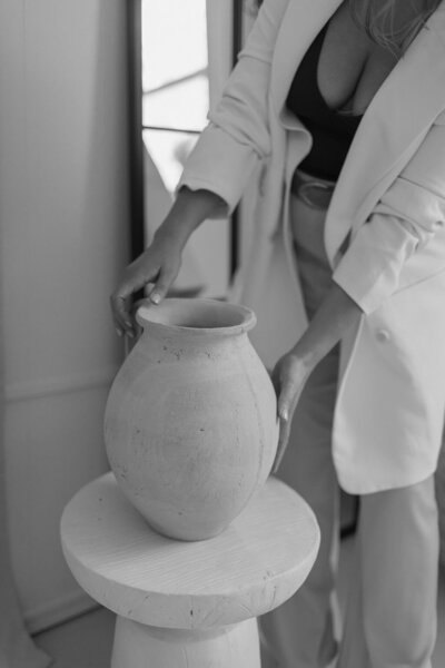Martina Biljan, copywriter and creative brand strategist, placing a vase on a pedestal