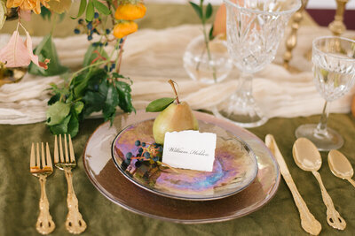 iridescent plate with pear sitting on top at winery wedding in idaho