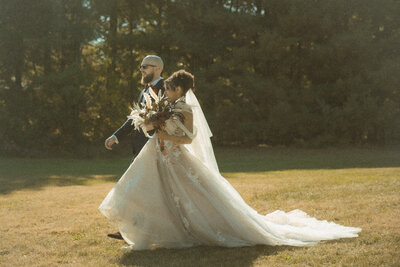 A married couple stands in a mysterious, editorial fashion on the steps of a vintage church 