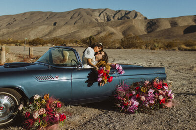 Las Vegas Desert Elopement in a Vintage car with bright florals
