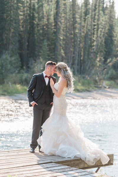 wedding photo of couple standing on a dock