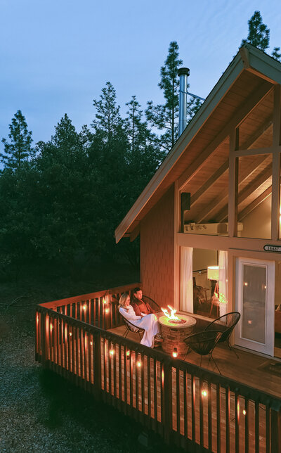 Bride and groom sitting on porch at night, by a colorado elopement photographer