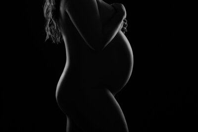 Artistic maternity boudoir photography that showcases the beauty of pregnancy.