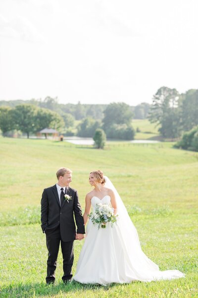Lynchburg bride and groom smiling at each other during their Lynchburg, VA Wedding Day at Spring Grove Ranch.