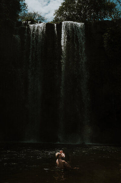 waterfall in costa rica proposal engagement photoshoot couple in the water