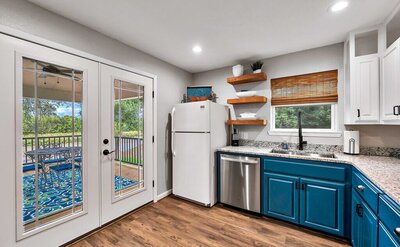 Kitchen with patio access in this 2-bedroom, 2-bathroom bungalow outside Waco, TX