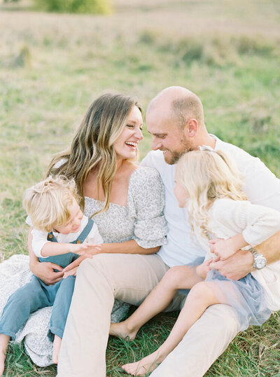 beautiful family sitting together during a summer photo session with Madison WI photographer Talia Laird Photography