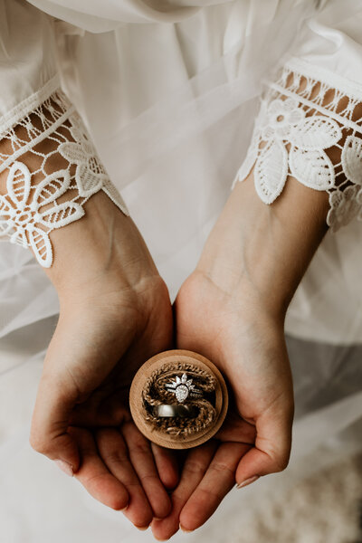 wedding rings in bride's hand