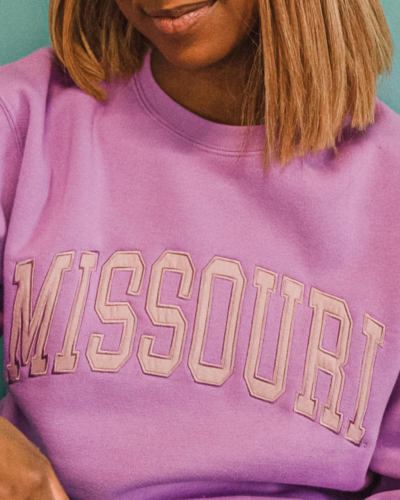 model wearing pink missouri crewneck sweatshirt