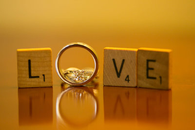 Scrabble tiles with wedding rings spell "Love". Photo by Ross Photography, Trinidad, W.I..