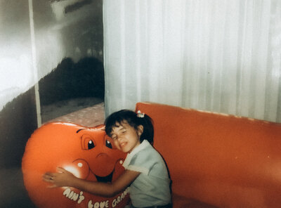 Child hugging heart ballon