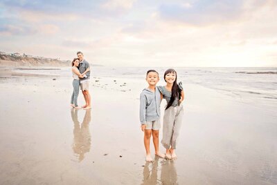 Fun photo of a family on the beach by Encinitas family photographer Tristan Quigley