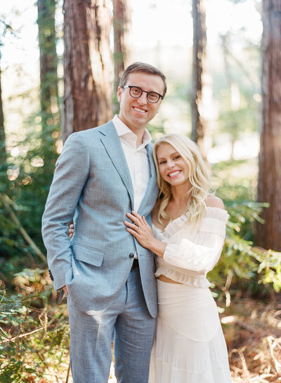 Bride and groom snuggle on a golden hillside during their engagement session in Walnut Creek California