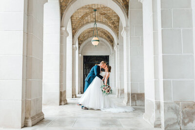 bride and groom dip kiss at the Nebraska State Capital Building