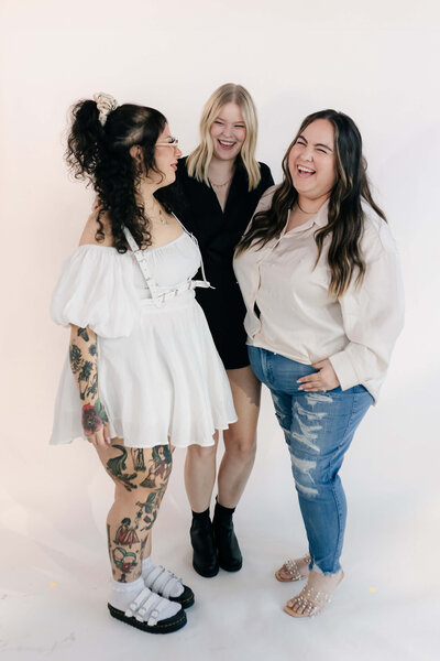 A photo of the SoCo staff linking arms, representing unity, connection, and strong community values.