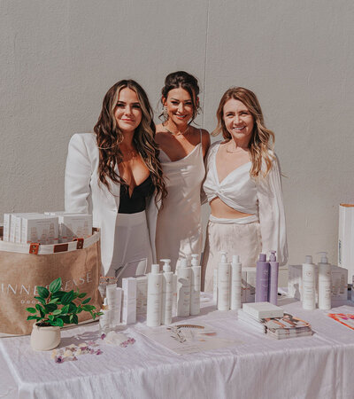 Cassandra posing with clients at event