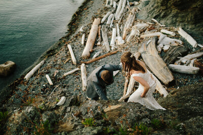 couple walking on driftwood beach on san juan island