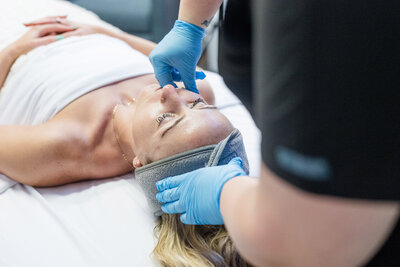 Client laying on a table getting a facial