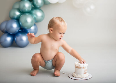 baby digging into cake