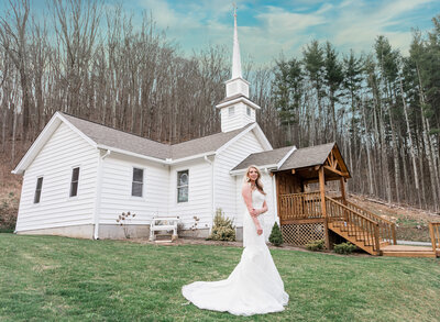 bride standing in front of a church looking at the camera