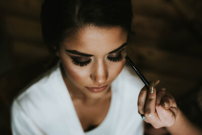 Luxury Wedding Portraits by Moving Mountains Photography in NC - Photo of a woman getting her makeup done.