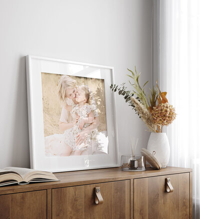 white framed photo of mother and child