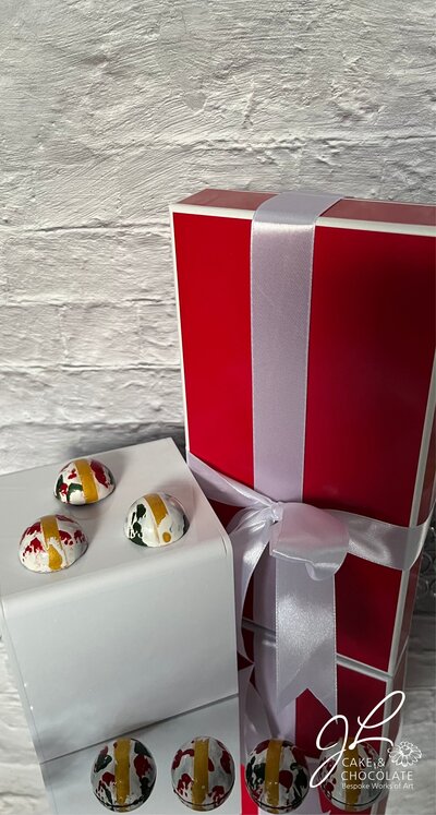 hand-painted luxury chocolate bonbons in gold, green, and red 