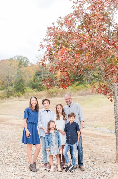 Family at Smith Park in Brentwood, TN posing for a photo on a pathway under a pretty tree