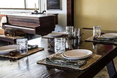 Location marketing Image Gatos Trail ranch table set for breakfast wood piano in background