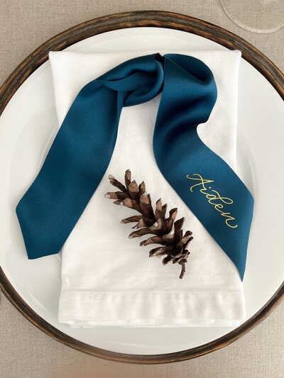 Peacock blue silk ribbon place cards with gold foil calligraphy