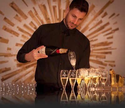 professional bartender pouring champagne