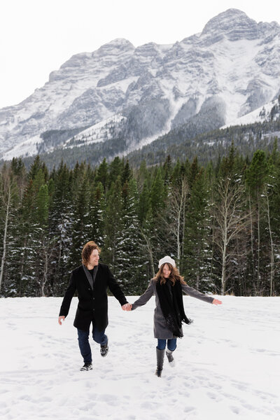 Couple kissing on treelined path in the Rocky Mountains