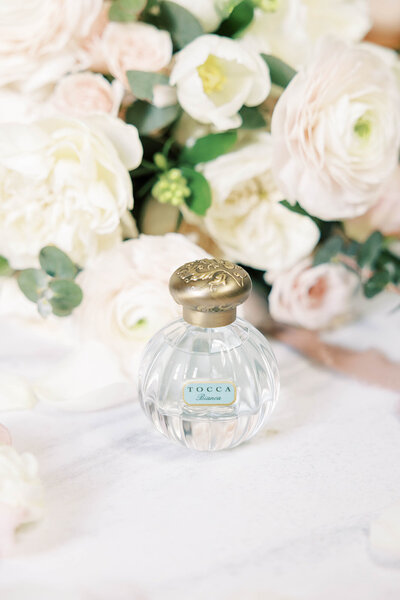 Tocca Stella perfume with elegant pink wedding florals
