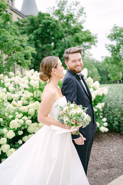 Portrait of a Bride and Groom in front of hydrangeas on their wedding day in South Bend