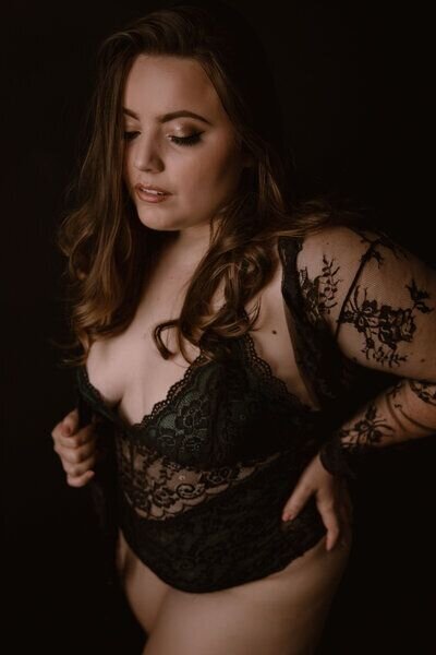 Beautiful woman posed sensually with a bodysuit and lace cover with her eyes closed