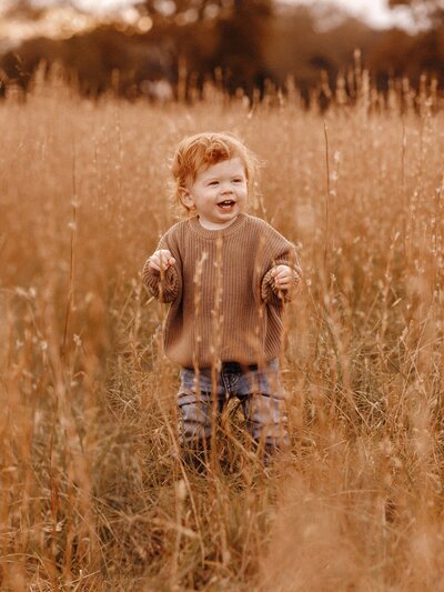 Toddler laughing and smiling during photography session