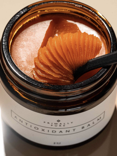 Jar of Primally Pure Antioxidant Balm with a small spoon.
