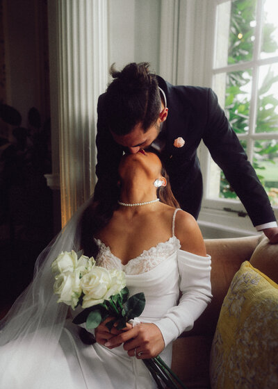 Cinematic, intimate moment between a bride and groom indoors, captured in a romantic film-inspired style by a luxury documentary wedding photographer UK.