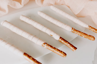 light pink white chocolate dipped pretzel rods