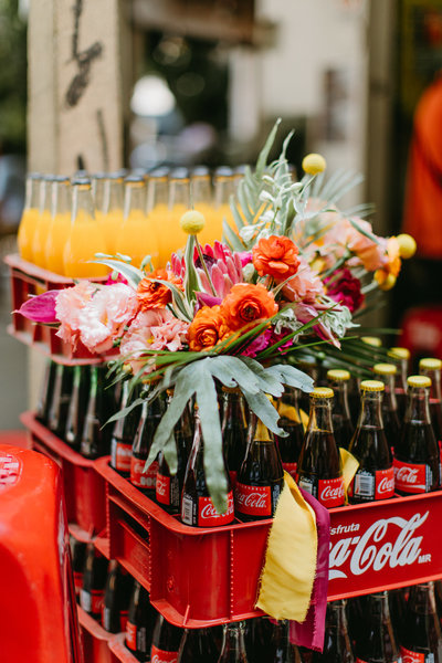 colorful bouquet on top of coca colas