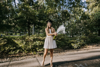 popping champagne at senior portrait photography session at hilton head